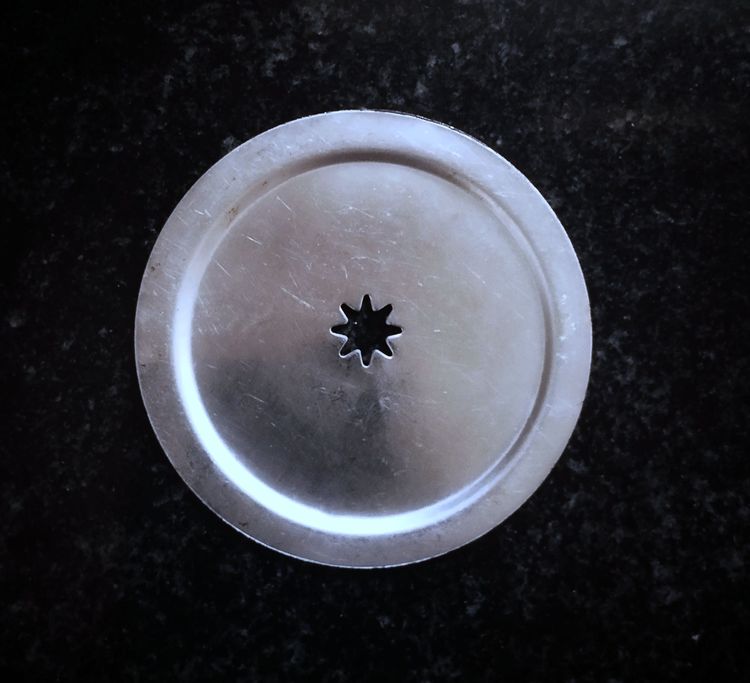 Step 1.1: Attach a star mold to the murukku maker and grease it with oil to prevent sticking