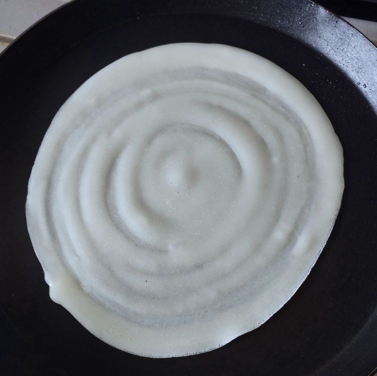 Step 3.1: Heat a tawa and pour one ladle of batter