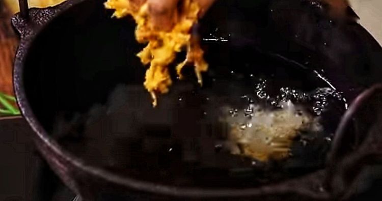 Step 1.1: Take a small portion of the cabbage mixture and gently drop it into the hot oil