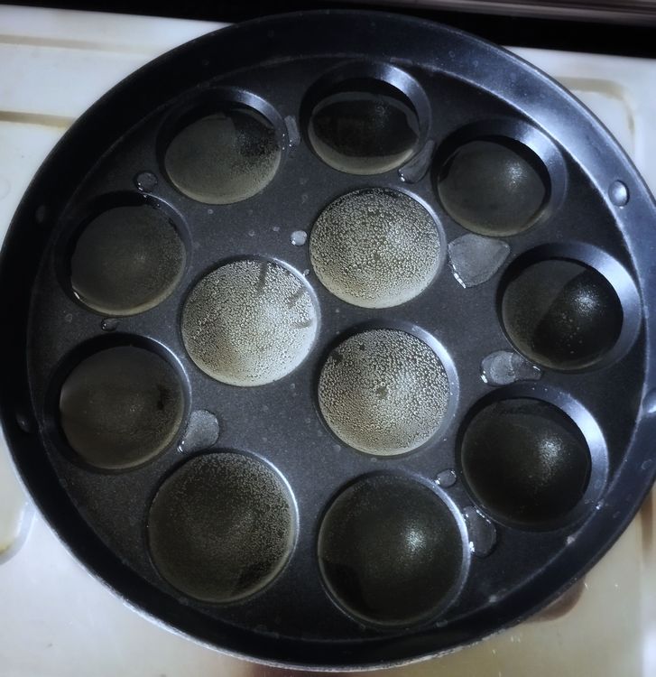 Step 1.1: Heat an Unniyappam pan and add oil to all the moulds