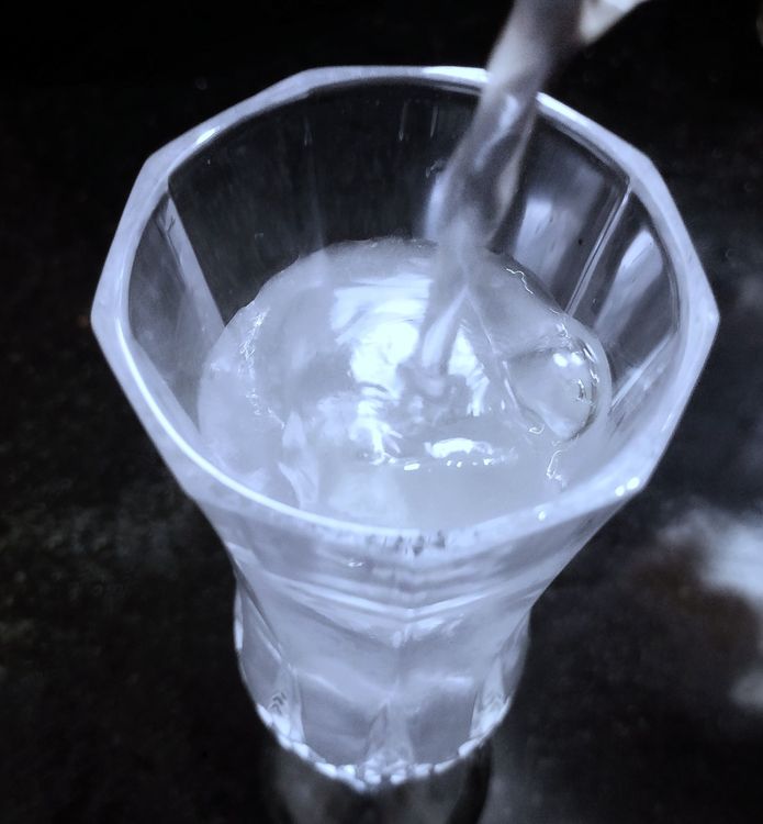 Step 1.2: Fill the glass with ice cubes and pour the chilled coconut water