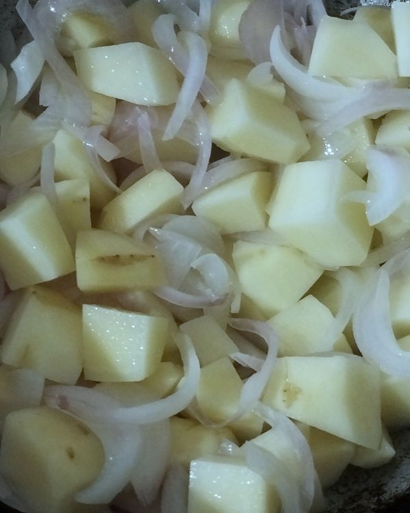 Step 1.1: Add curry leaves and potato pieces