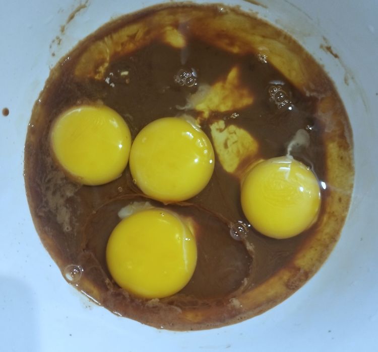 Step 2.1: Add eggs and vanilla essence to the mixture and combine well with a whisk or fork