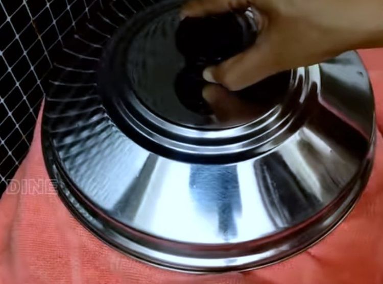 Step 2.1: Place the cake tin in a steamer and cover the steamer with a cotton towel before closing it with a lid