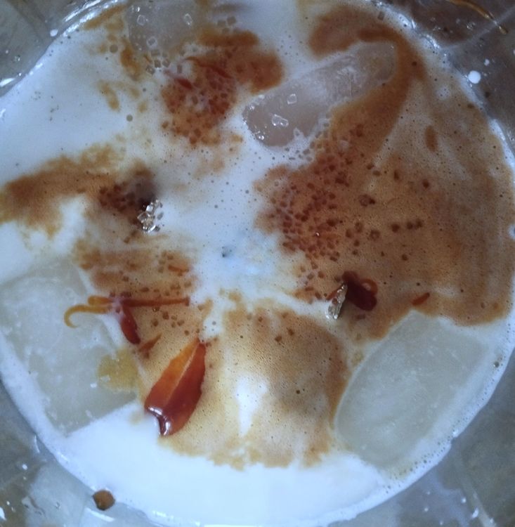 Step 3.1: To a blender, add ice cubes, chilled milk, beaten coffee mix, sugar (only if you need), and caramel syrup