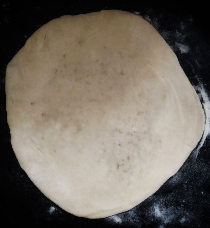 Step 3.1: Dust some flour and roll the paratha into a round shape, about 7 to 8 inches in diameter