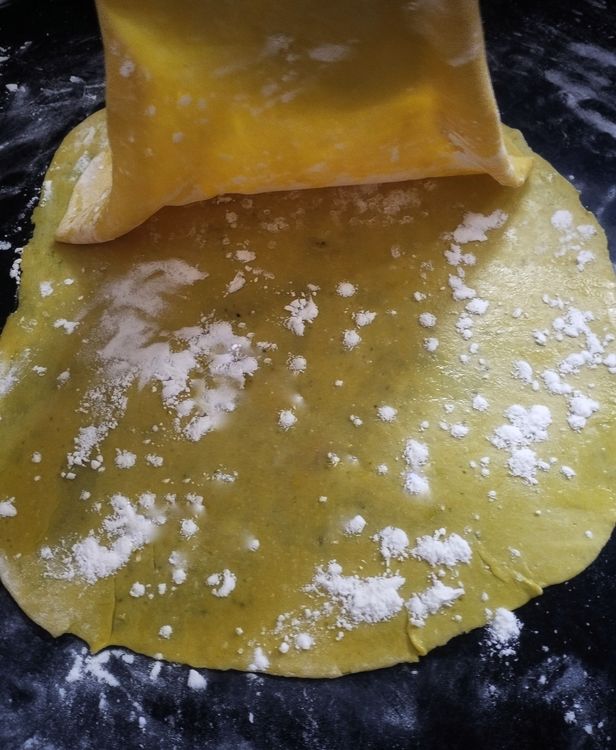 Step 2.1: Place the second dough sheet on top, spread oil, and dust flour again