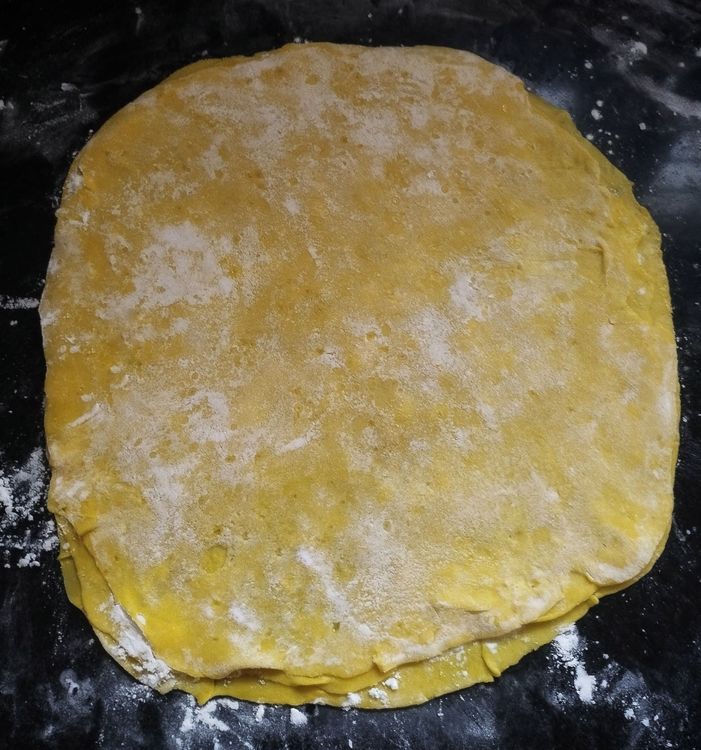 Step 2.1: Place the third dough sheet on top and dust flour over it without spreading oil