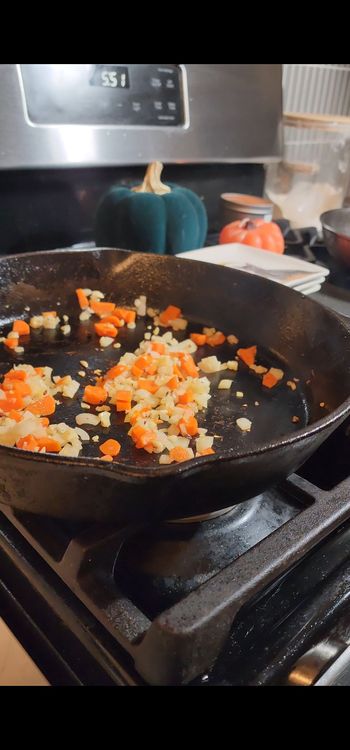 Step 1.1: Add garlic, onion, and carrot to the pan and cook for 2-3 minutes