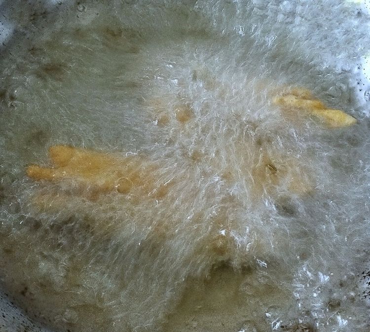 Step 1.1: Drop the shaped strips into the hot oil and fry on medium flame until golden brown