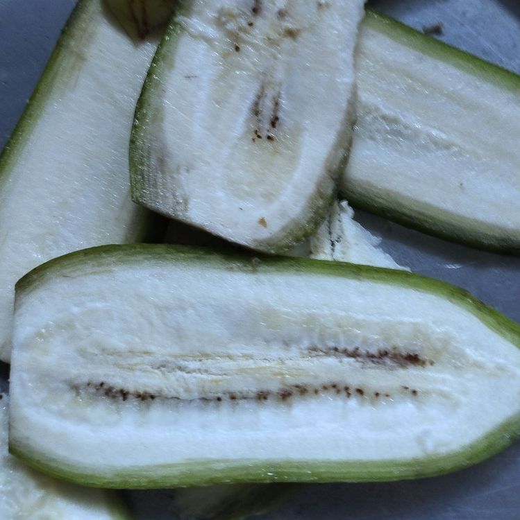 Step 1.1: Peel the raw banana slightly and slice them into medium-thick slices