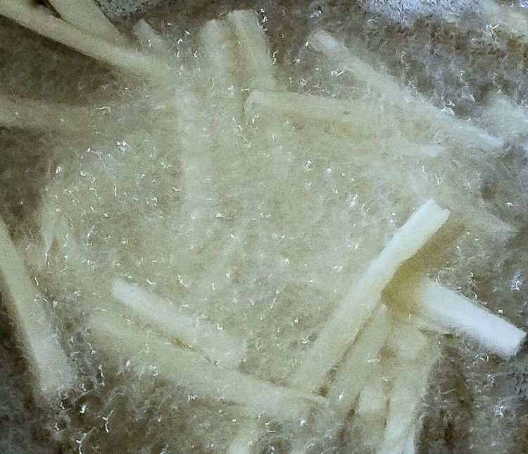 Step 1.1: When the oil becomes hot, add the tapioca strips and fry until crispy on medium flame
