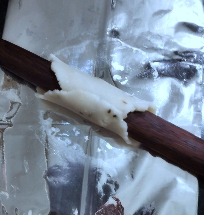 Step 1.1: Using a greased rod or thin rolling pin, roll one side of the circle and bring the other side over to seal the edges, forming a tube-like shape