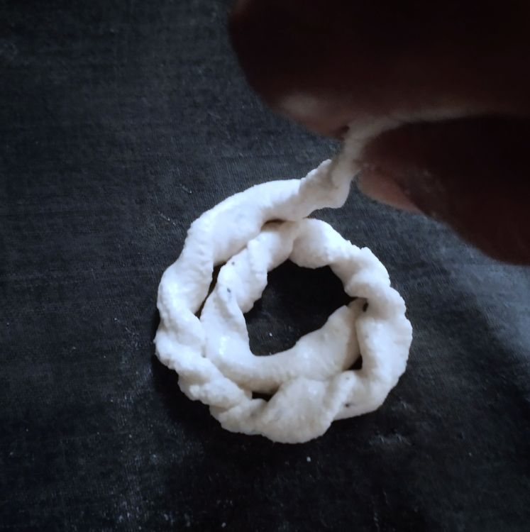 Step 1.2: Gently twist and roll the dough using your fingers to form a spiral or coil shape on a cotton cloth