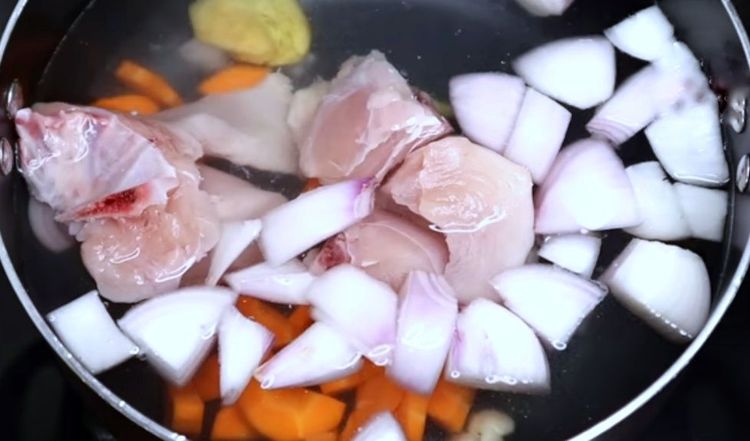 Step 1.1: Boil water along with chicken pieces, onion pieces, carrot pieces, chopped ginger, chopped garlic, pepper powder, and salt