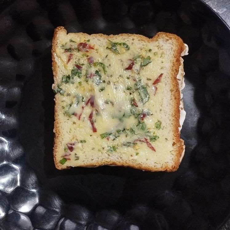 Step 1.1: Spread the garlic-butter mixture evenly on both sides of the bread sandwich