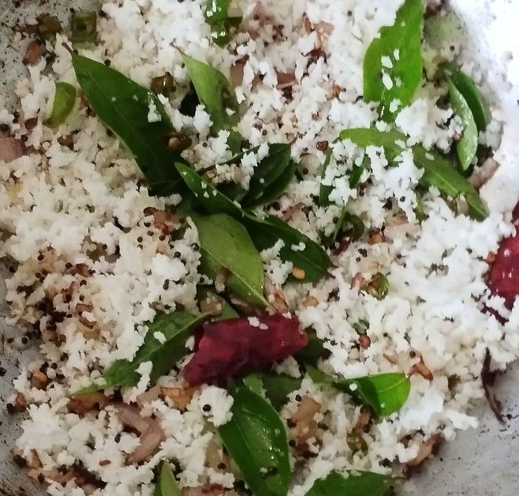 Step 1.1: Add grated coconut and sauté for 1 minute