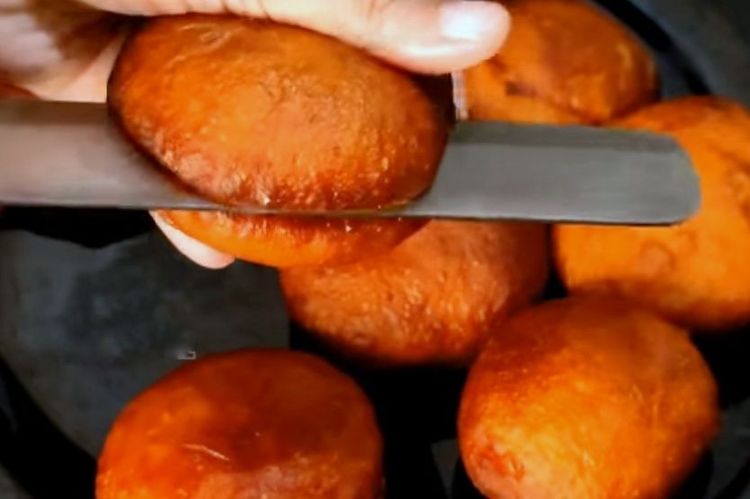Step 4.1: Take the cooled fried buns and slit them open in half