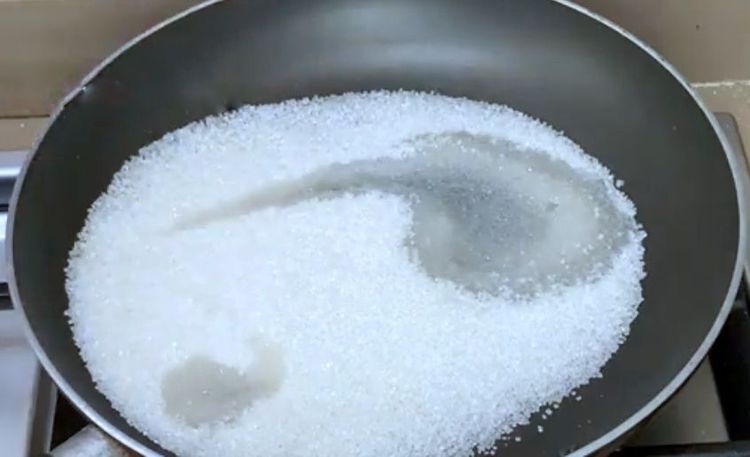 Step 1.1: In another pan, boil sugar along with water