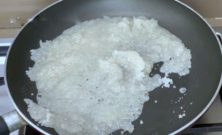 Step 1.1: When the sugar starts melting, add the grated coconut