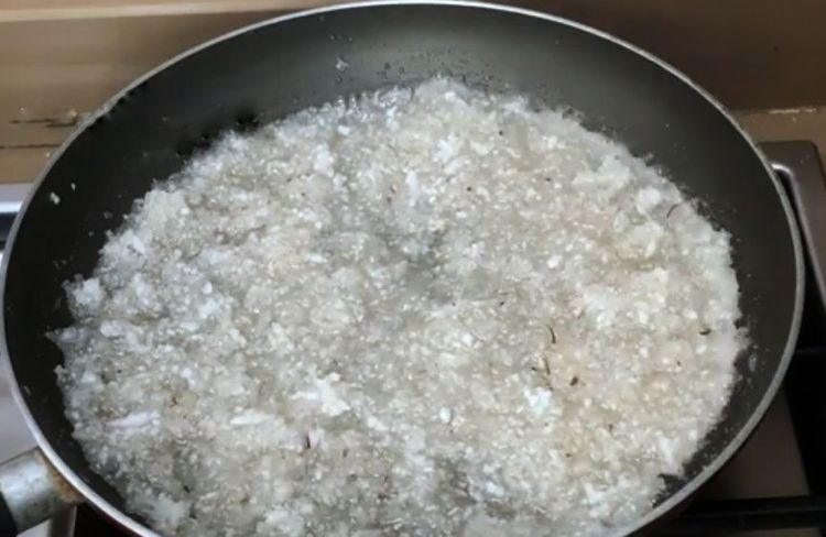 Step 1.2: When the sugar starts melting, add the grated coconut