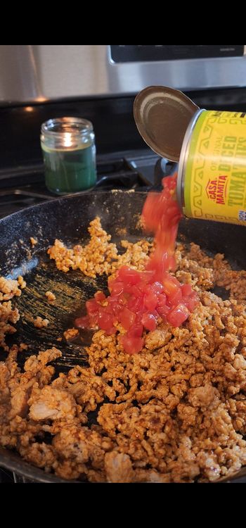 Step 1.2: Stir in diced tomatoes with green chilies, aji amarillo paste, and taco seasoning