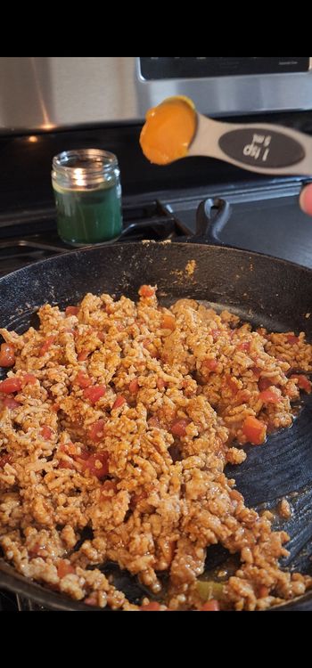 Step 1.3: Stir in diced tomatoes with green chilies, aji amarillo paste, and taco seasoning