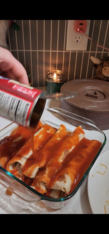 Step 1.1: Pour remaining enchilada sauce over enchiladas and top with remaining cheese