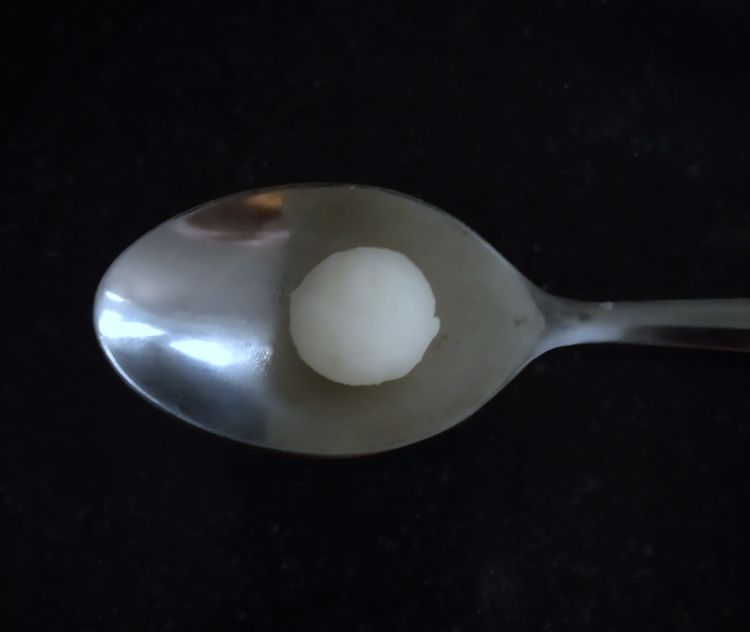 Step 2.1: Pinch small portions of the dough and roll them into small marble-sized balls