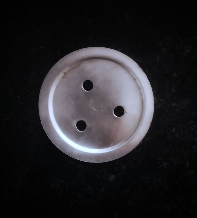 Step 1.1: Grease a murukku press or sev press with a holed disc and fill the dough into the press