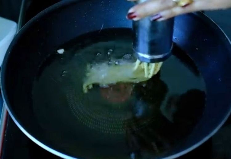Step 2.1: Press the dough directly into the hot oil in circular motions, ensuring not to overcrowd the pan