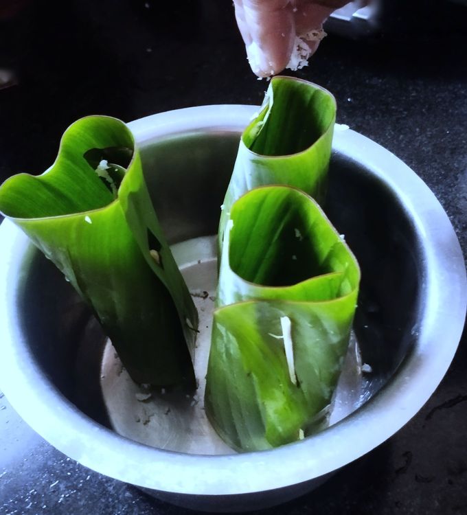 Step 1.1: To start layering, place the cylinder-shaped banana leaf into a plate or bowl