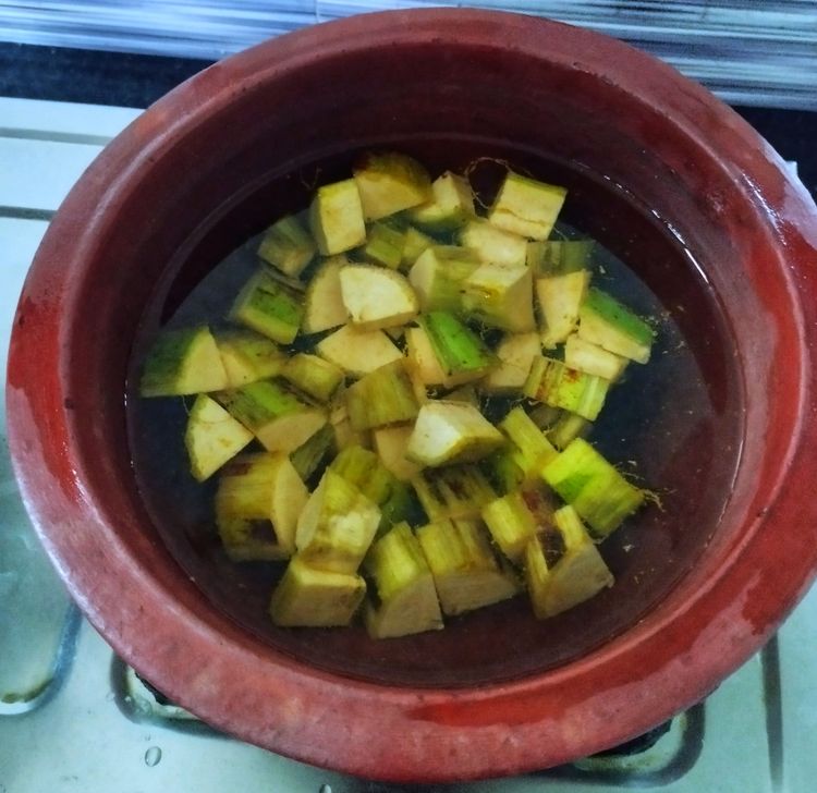 Step 1.1: In a thick-bottomed pan or in a earthen pot, add the cubed yam and banana