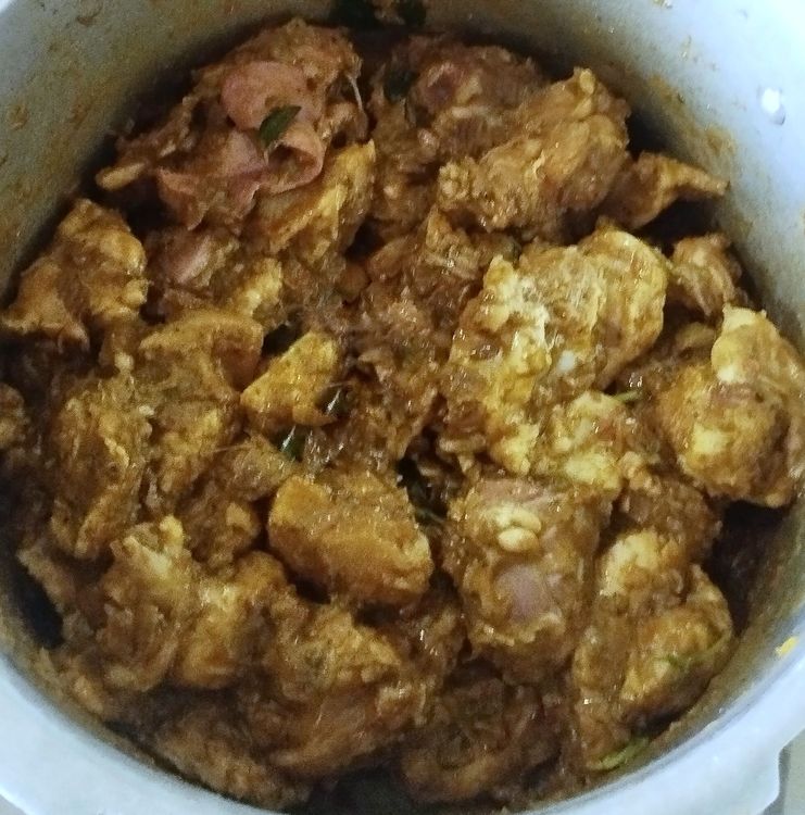 Step 4.1: Add the cleaned chicken pieces and mix well to coat with the masala