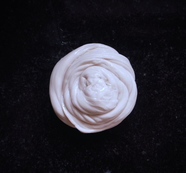 Step 2.3: Fold into a roll, then gently stretch it and shape into a coil, and gently flatten again into a paratha shape