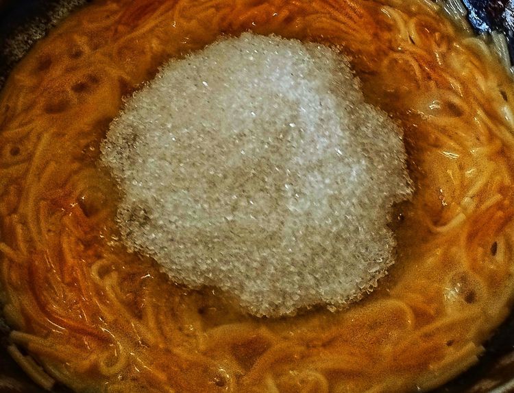 Step 4.1: Reduce heat to low and add sugar