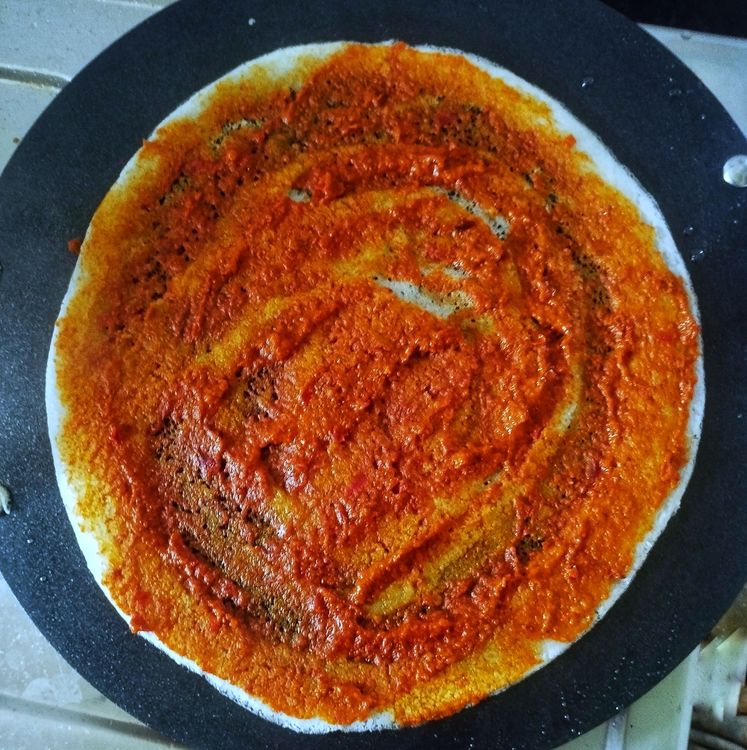 Step 4.1: Spread a thin layer of red chutney on the dosa