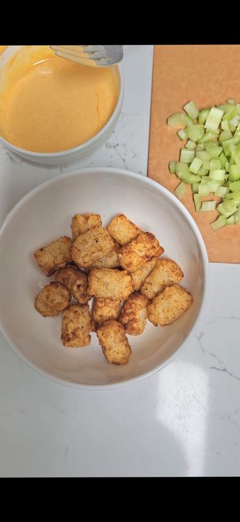 Step 4.1: In each bowl, place a portion of tater tots