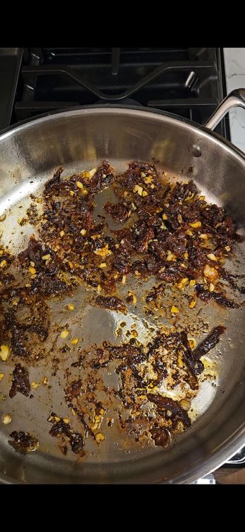 Step 2.1: In the same pan, add garlic and sun-dried tomatoes