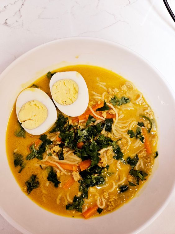 Step 5.1: Top with boiled eggs, cilantro, green onions, and a squeeze of lime