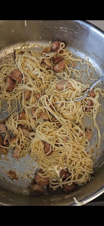 Step 4.1: Reduce heat to low and toss the cooked pasta with the sausage in the pan