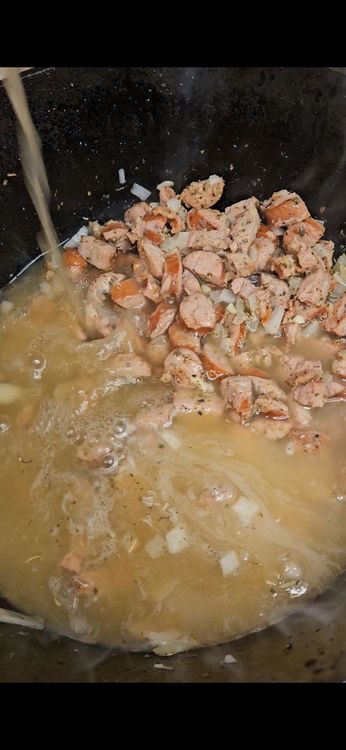 Step 3.1: Gradually pour in the chicken stock while stirring to prevent lumps