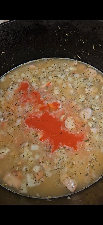 Step 4.1: Add tomato sauce and Parmesan rind, chicken bouillon cube, red pepper flakes, and bay leaf, if using