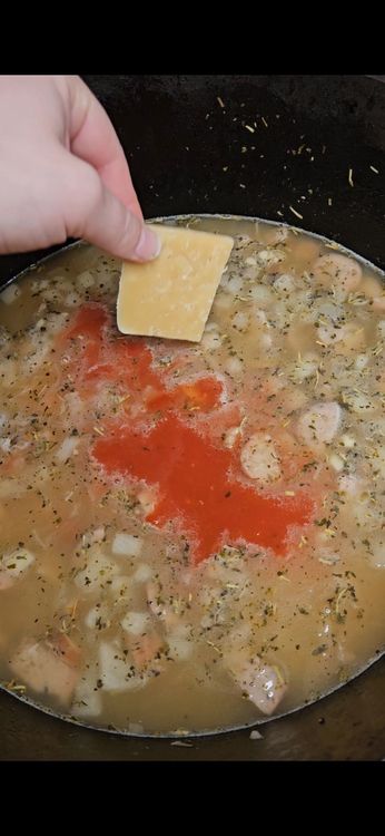Step 4.2: Add tomato sauce and Parmesan rind, chicken bouillon cube, red pepper flakes, and bay leaf, if using
