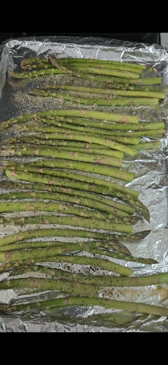 Step 1.1: Add salt, pepper, garlic powder, lemon zest, and Parmesan cheese to the asparagus