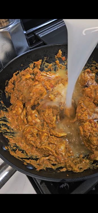 Step 1.2: Return the chicken to the pan, mix well, and add water
