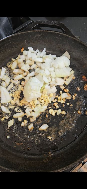 Step 2.1: In the same pan, add butter, diced onion, and minced garlic