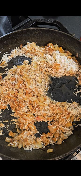 Step 2.2: Add tomato paste and rice to the pan
