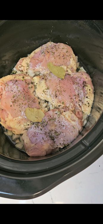 Step 2.1: Sprinkle oregano, thyme, and bay leaves over the chicken