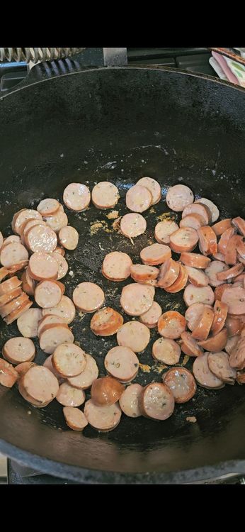 Step 1.1: Add the sliced sausages and cook for 2-3 minutes